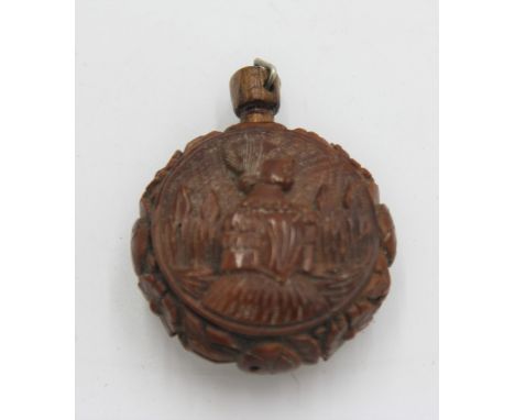A European coquilla nut perfume bottle, carved with a male and a female portrait, height 5cm. 