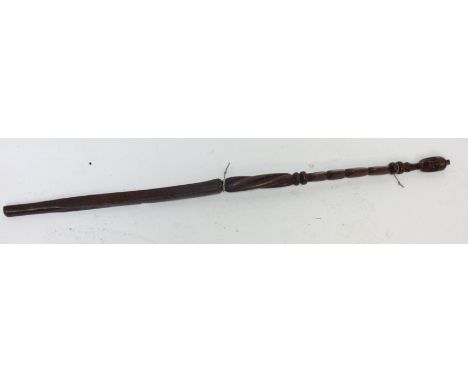 An African carved wood tiller, 19th century, the handle carved with a portrait mask, length 107.5cm. 