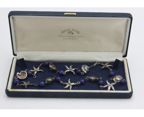 A contemporary silver and lapis necklace with starfish and snail beads, box of Rebecca Morgan Smith.