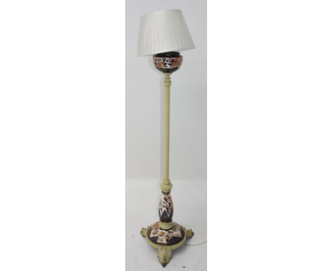 An unusual yellow painted metal and porcelain standard lamp, height 157cm.