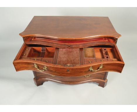 A fine George III mahogany serpentine gentleman's dressing chest, with moulded top and blind fret canted corners fitted four 