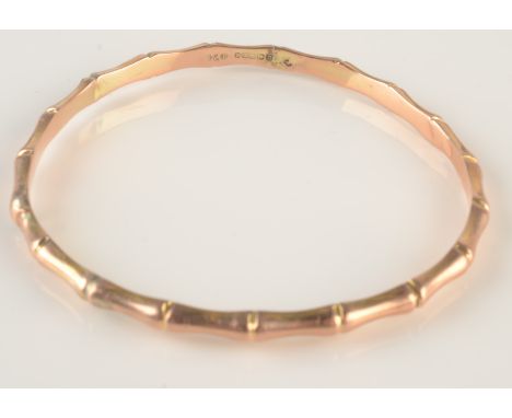 A hollow 9ct gold bangle simulating bamboo, 6g.