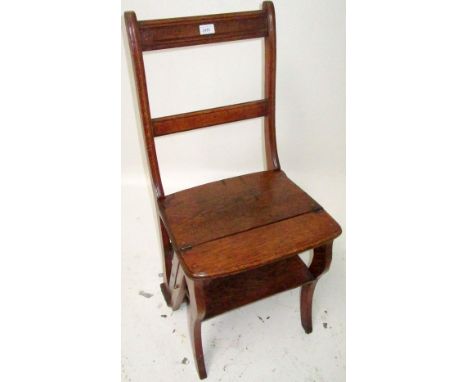 An Edwardian oak metamorphic library chair, with arcaded top rail, folding seat, converting to a four tread step, height 89cm