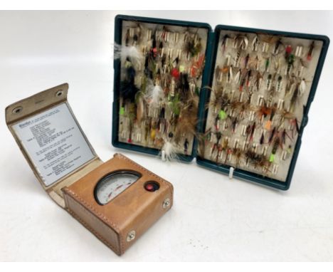 A large collection of assorted fishing flys, contained in a Fox Box and a light meter. 