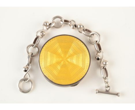 An enamelled silver compact and a silver bracelet.