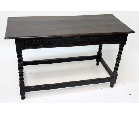 An oak table in Carolean style and incorporating some 17th century timbers, the frieze lunette carved, one side with two draw