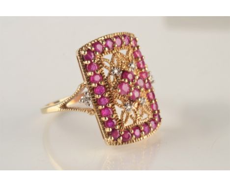 A yellow gold filigree style ring set with rubies and diamonds.
