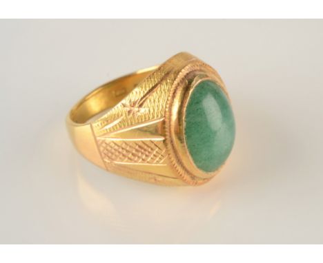 A contemporary Chinese 22ct gold jade set ring, 15.6g.