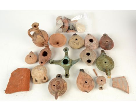 An antique terracotta oil lamp, labelled 'Italy circa 400AD', and a collection of other earthenware and metal lamps, a potter