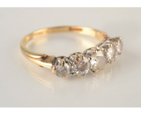 An 18ct yellow gold five stone diamond ring. Condition report: Centre diamond has small chip and also the next diamond has a 