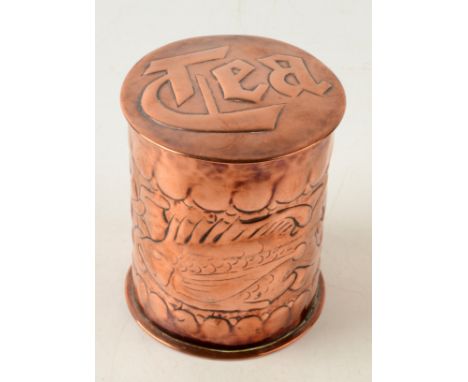 A Newlyn copper circular tea caddy, the body decorated with two fish, impressed Newlyn, height 10cm, diameter 8.5cm. Conditio