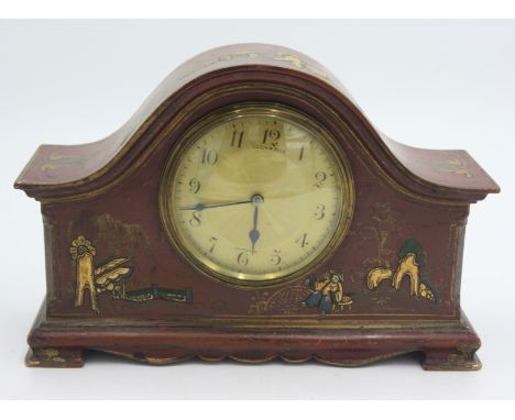 A Mappin and Webb chinoiserie lacquered red ground small mantle clock.