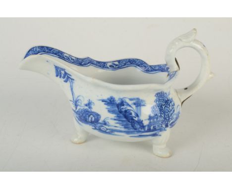 An early Bow porcelain sauce boat of silver shape, blue painted with the 'Two Pavilions' pattern, old brass rivet repairs to 