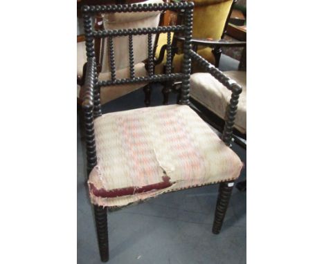 A Victorian ebonised bobbin turned armchair, height 82cm, width 54cm. Condition report: Wood wormed front legs.