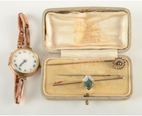 A ladies gold cased wristwatch on expanding gold bracelet, together with a gold stick pin and a gold bar brooch.