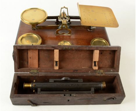 A set of Victorian walnut and brass post office scales, width 35.5cm and a cased surveyors level, width 26.5cm.