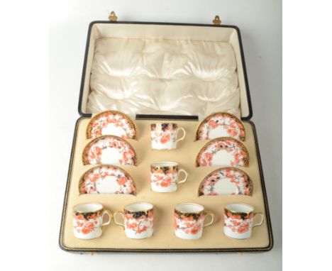 A set of six Royal Crown Derby porcelain coffee cans and saucers, in original leather case, red painted number 2649, height o