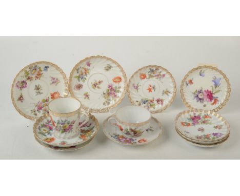 Ten various German outside decorated saucers painted in Deutsch Blumen style with gilt borders together with ten similar cups