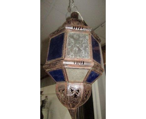 A Moroccan painted metal hanging lantern, 20th century, inset with alternating blue and clear etched glass panels, height 40c