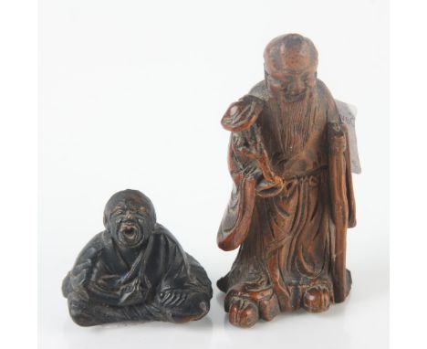 A Chinese carved wood okimono and a netsuke, heights 8 and 3.5cm. Condition report: Loss to smaller figures rear of head 