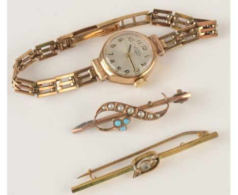 A ladies gold cased Rotary wristwatch on 9ct. gold bracelet, together with two gold bar brooches.