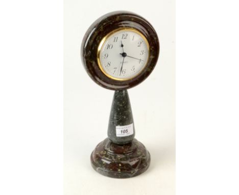 A Cornish serpentine mantel clock, height 32cm, diameter 15cm.