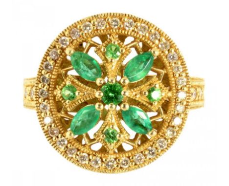 AN EMERALD AND DIAMOND RING  OF CIRCULAR DESIGN WITH CENTRAL OPENWORK CLUSTER OF ROUND AND LARGER NAVETTE SHAPED EMERALDS, DI