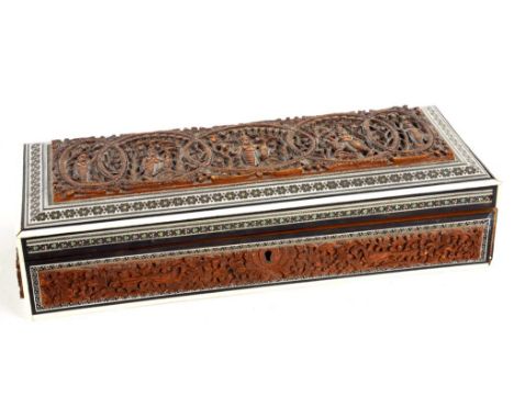 AN INDIAN CARVED SANDALWOOD, EBONY, IVORY AND SADELI GLOVE OR TRINKET BOX, 31CM W, LATE 19TH C