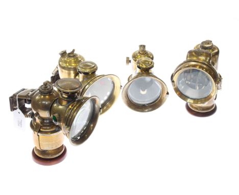 Collection of four vintage brass cycle lamps
