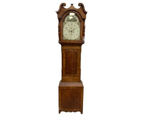 An Oak and Mahogany longcase clock with a Swans neck pediment and break arch hood door flanked by two ring turned pillars wit