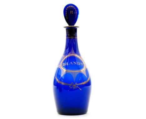 A late 18th Century Bristol blue decanter circa 1780 of Indian Club form with a lozenge form stopper gilded with BRANDY withi