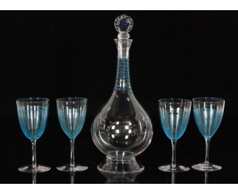 An early 20th Century continental crystal glass decanter of conical footed globe and shaft form with applied sapphire trail t