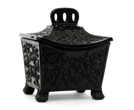 A late 19th Century Sowerby black pressed glass miniature tea caddy in the Aesthetic taste of tapering rectangular form to th