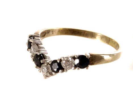 A seven stone gem set wishbone dress ring, the alternating clear and dark stones set on a yellow metal band, size Q 