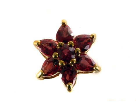 A 9ct gold ruby floral cluster pendant, having central round cut stone surrounded by six pear shaped stones, marked to back 3