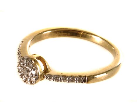 A 9ct gold diamond ring, the circular tablet top mounted with multiple round cut diamonds, flanked by five round cut diamonds