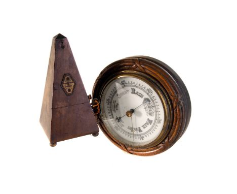A diaphragm barometer by Sutton & Sons, mounted in a wooden frame with reed and stitch moulding, 24cm diameter, together with