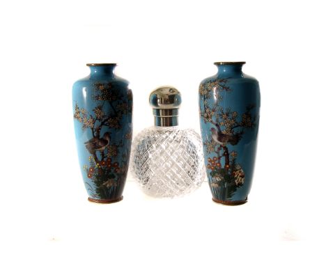 A pair of Meiji period light blue ground cloisonné vases, having bird amongst foliate decoration, together with a silver topp