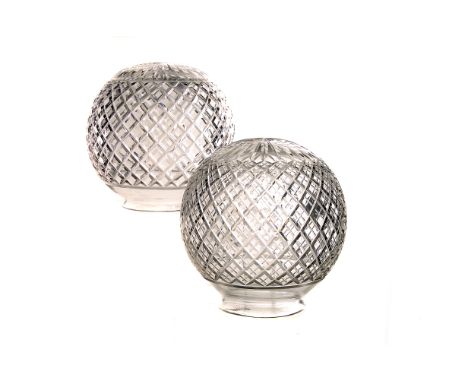 A pair of cut glass light shades, the spherical shades with criss cross cut glass design (2) 