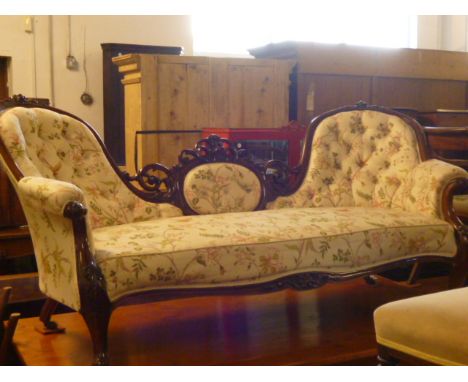 A Victorian French walnut bucket end sofa,  with carved floral cartouches and a serpentine seat on cabriole legs to brass cas