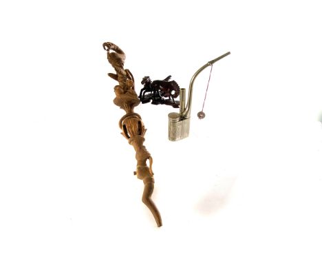 An chromed opium pipe, together with a selection of carved oriental horse figures, plus an oriental book, and Tribal staff (p