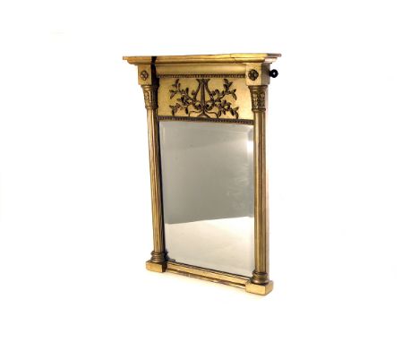 A gilt framed bevelled glass wall mirror, having column design to side, with architectural vine and musical instrument design