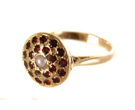 A pearl and garnet target ring, the central pearl surrounded by circular garnets 