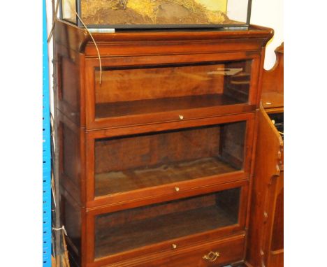 An Edwardian mahogany "knock down" bookcase cabinet, the Globe Wernicke style unit with glazed lift doors in three sections, 