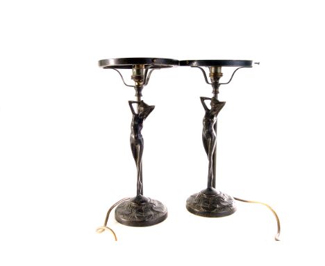 A group of three lamps, two of figural form, together with four glass lamp shades 
