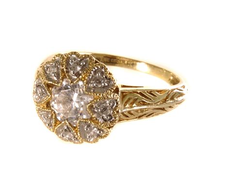 A 14ct gold and cubic zirconia dress ring, the cluster style circular tablet set with a large cut stone and smaller examples,