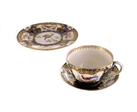 A Regency ceramic cup and saucer,  having floral and bird decorated panels, with blue and gilt design, together with matching