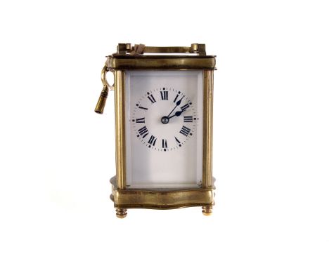 A French brass and glazed carriage clock, having white dial with black Roman numerals, with key 