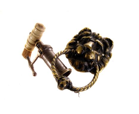 A vintage bone handled corkscrew, together with a brass lion mask door handle, AF 