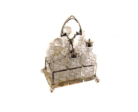 A six piece cut glass cruet set,  the silver plated stand of rectangular base, to four ball feet, together with a cut glass d